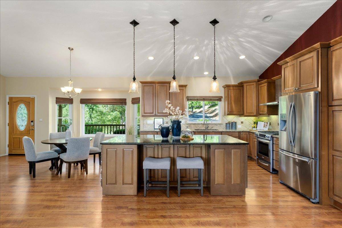 Nestled on 9.3 acres, this 3 bed, 3 bath estate offers 3,672 sq ft of living space with gorgeous views, a built-in pool, owned solar, koi pond, hidden guest quarters, & lush landscaping! Through the front door you're immediately captivated by the grand living space and stunning views of the rolling hills beyond. The updated kitchen shines with granite countertops and a showstopping custom center island, ideal for entertaining. The dramatic light filled primary suite offers deck access, a laundry room, office, and flex space. While the ensuite bath features a sunken tub perfectly positioned to enjoy serene views, as well as a walk in closet for ample storage. Enjoy outdoor living from the back deck with built in BBQperfect for unwinding with a sunset glass of local wine. Or enjoy your morning coffee surrounded by butterflies and hummingbirds on the tranquil front deck. Energy efficient features include owned solar, dual-zone HVAC, automatic whole house generator, a high-producing well, and 1 acre-foot of PCWA ditch water. The property also includes a 1,100 sq ft non-conforming 3bed, 1bath apartment/ finished basement with private entrance ideal for guests, multi-gen living, or potential rental income. A rare retreat offering privacy, comfort, and incredible potential!